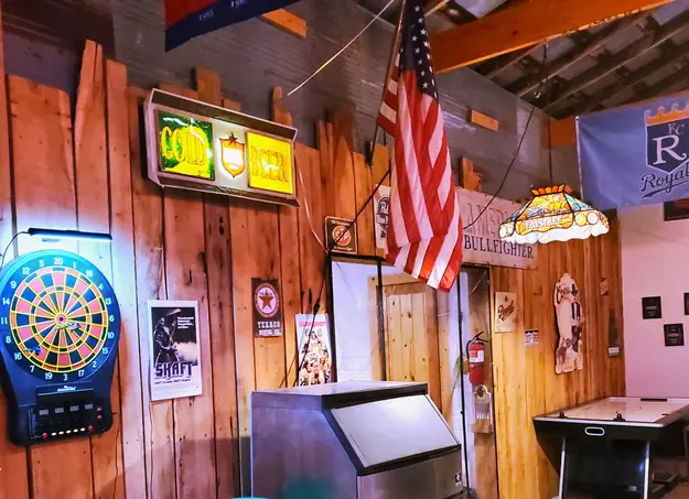 ice maker and dartboard inside the barn at sidetrack rv park